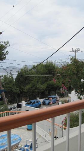 a balcony with cars parked in a parking lot at Tatsis Apartments in Masouri