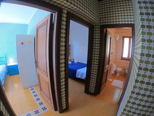 a view of a bedroom with a bed and a door at Ammiraglio in Campese