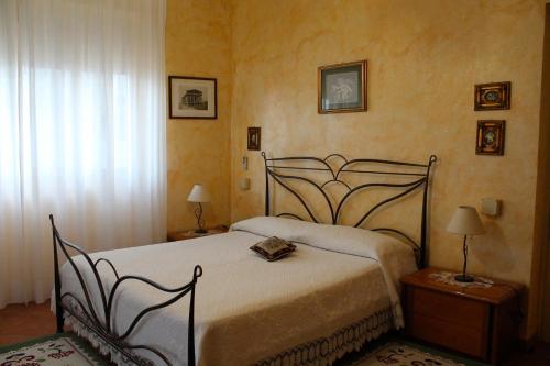 a bedroom with a bed and two tables with lamps at Apartment Terrazza Greca in Agrigento