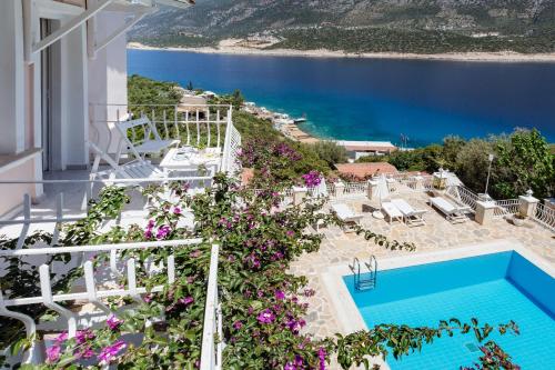 a view from the balcony of a hotel with a swimming pool and flowers at Club Çapa Hotel in Kas