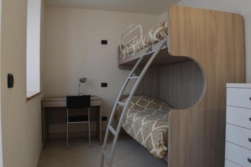 a bedroom with a bunk bed and a desk at Appartamenti al Canton in Colà di Lazise