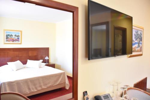 a bedroom with a bed and a large mirror at Villa Riva in Makarska