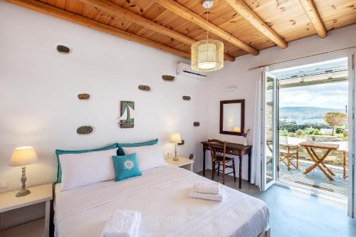 a bedroom with a bed and a table and a desk at Exochi Traditional Houses in Krotiri