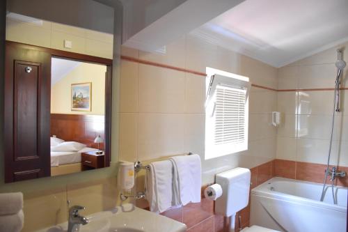 a bathroom with a sink and a toilet and a mirror at Villa Riva in Makarska
