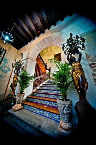 a staircase in a building with potted plants at Hotel Condes de Castilla in Segovia
