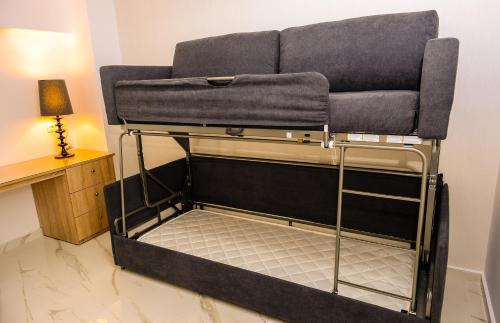 a couch sitting on a bed in a room at Island Dreams Rooms & Suites in Rhodes Town