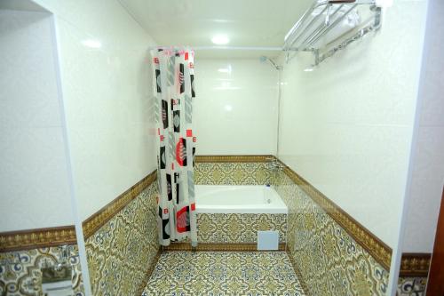 a bathroom with a bath tub in a room at Muso To'ra in Khiva