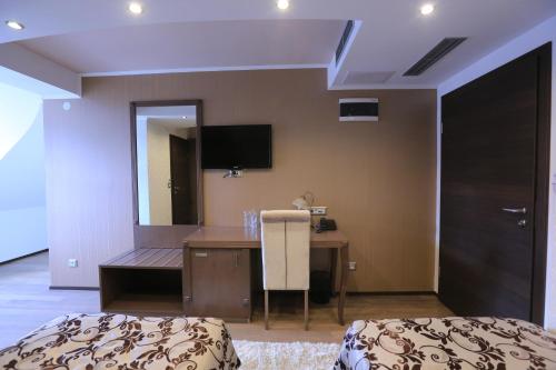 a hotel room with a desk and a bed at City Palace Hotel in Ohrid