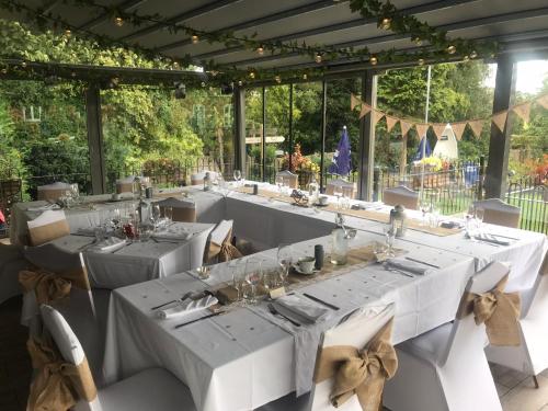 a long table with white tables and chairs at Strawberry Bank Hotel, NEC in Meriden