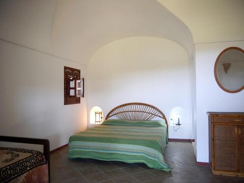 a bedroom with a bed in the corner of a room at I Dammusi Sapori di Pantelleria in Pantelleria