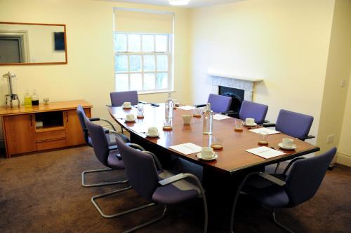 a conference room with a long table and chairs at Strawberry Bank Hotel, NEC in Meriden