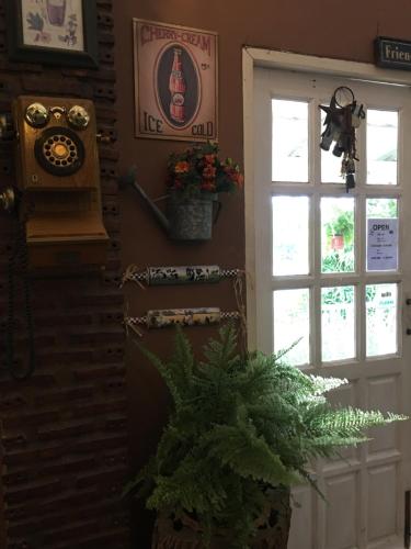 a room with a door and a window and a plant at The Green land (Khok Kruat) in Nakhon Ratchasima