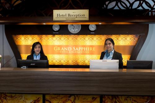 two people sitting at a desk with laptops at Grand Sapphire Hotel & Banqueting in Croydon