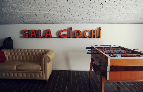 a living room with a couch and a table and a sign at The Hostello in Verona