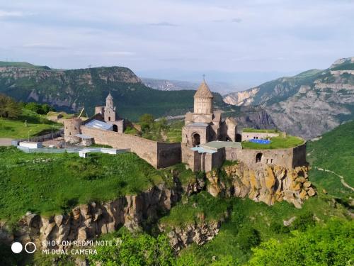 an old monastery on a hill in the mountains at Ana-Maria Bnb in Tatʼev