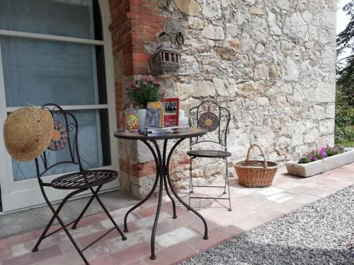 a table and two chairs on a patio at B&B CASAGRANDE in Quercegrossa