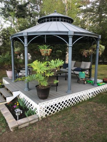 a gazebo in a yard with plants at Welcome to the Lake in Northwood