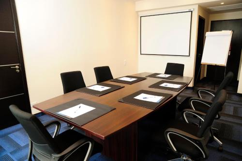 a conference room with a long table and chairs at Novotel Panama City in Panama City