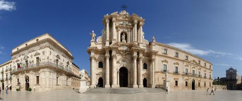 a large stone building with a clock tower at Villa Carmela Arenella in Arenella