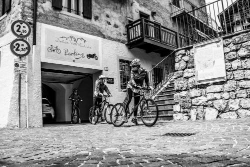 two people on bikes outside of a building at DolceVita Ambiez B&B in San Lorenzo in Banale