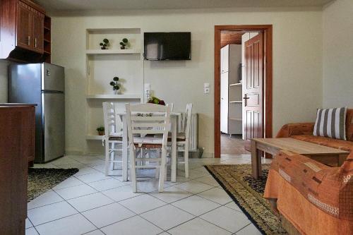 a kitchen and living room with a table and chairs at Alexis's House in Pylos