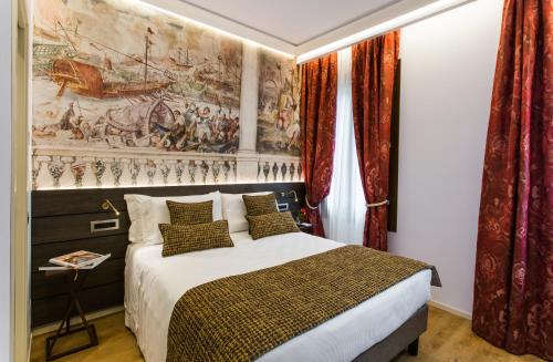 a bedroom with a bed with a painting on the wall at Venice Maggior Consiglio in Venice