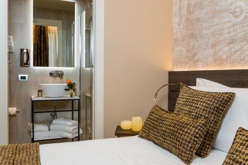 a bedroom with a bed and a bathroom with a sink at Venice Maggior Consiglio in Venice