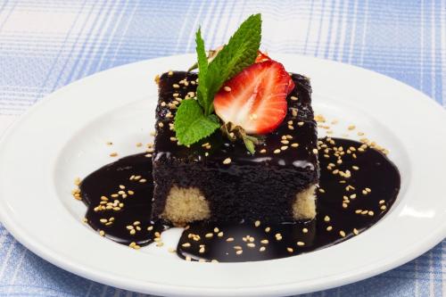 a piece of chocolate cake with a strawberry on a plate at Casa Santa Elena in Santa Cristina d'Aro