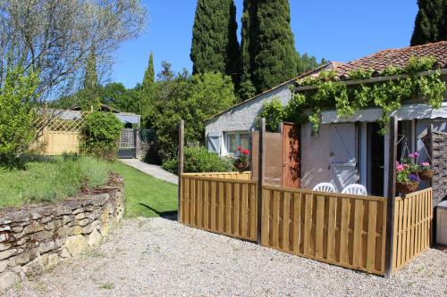 a house with a fence and a garden at Les Pics Blancs in La Courtète