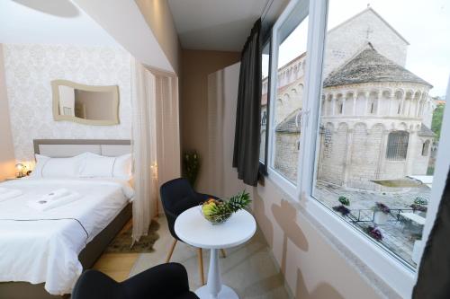 a hotel room with a bed and a window at Zoilo Rooms self check-in in Zadar