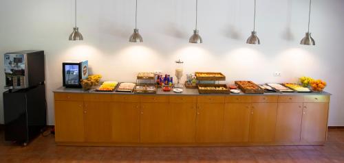 a counter with cakes and desserts on top of it at Casa Santa Elena in Santa Cristina d'Aro