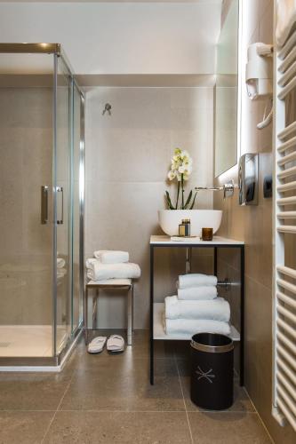 a bathroom with a shower and a sink and towels at Venice Maggior Consiglio in Venice