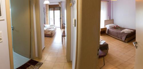 a hallway with a living room and a bedroom at studio nufaro in Mytilini