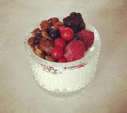 a bowl of berries and nuts on a table at Livgrenadjärmässen Hotell-Fest-Konferens in Linköping