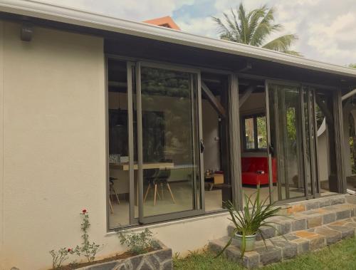 a screened in porch of a house at Luxury Cosy Guesthouse in Pamplemousses Village