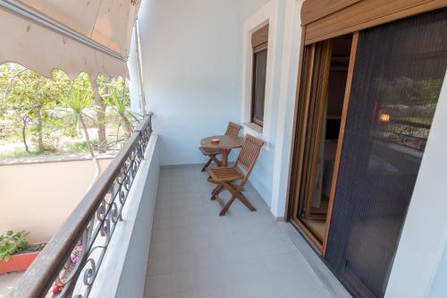 a balcony with a chair and a window at studio nufaro in Mytilini