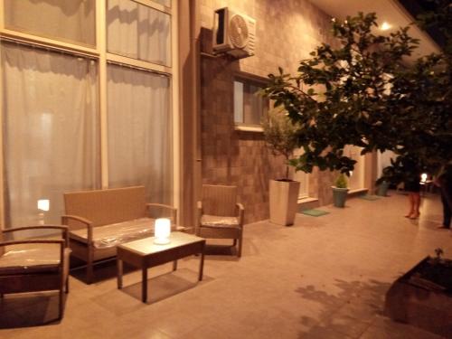 a room with chairs and a table with a candle on it at Vonitsa Loft Apartment 1 in Vonitsa