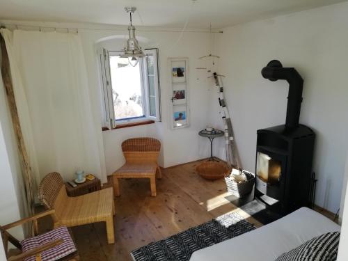 a living room with a wood stove in it at Ca' Flora in Nerezine