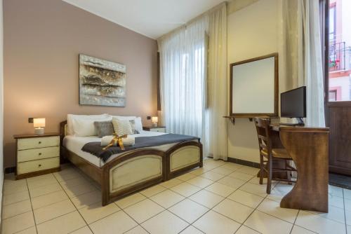 Ένα ή περισσότερα κρεβάτια σε δωμάτιο στο Arcobaleno Rooms