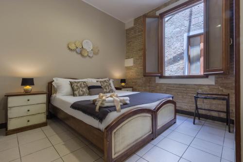 a bedroom with a bed with a teddy bear on it at Arcobaleno Rooms in Cagliari