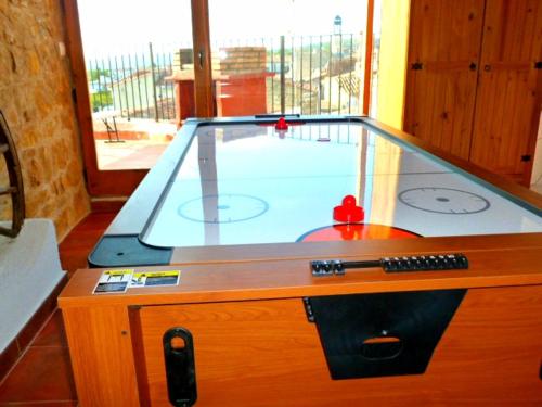 a pool table with a glass top in a room at Casa Alba in Xert