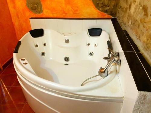 a white bath tub sitting in a bathroom at Casa Alba in Xert