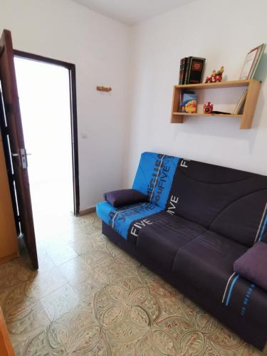 a couch sitting in a living room with a door at Casa rural Juan y Juana Canino in Tejeda