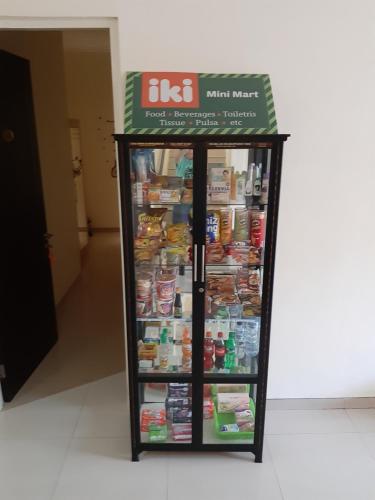 a refrigerator with food inside of a building at Ikiru to Live in Surabaya