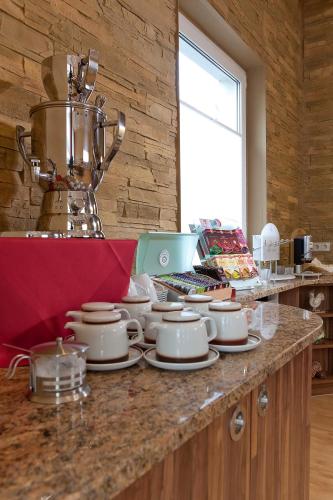 a counter with plates and bowls on top of it at Hotel Bavaria Oldenburg in Oldenburg