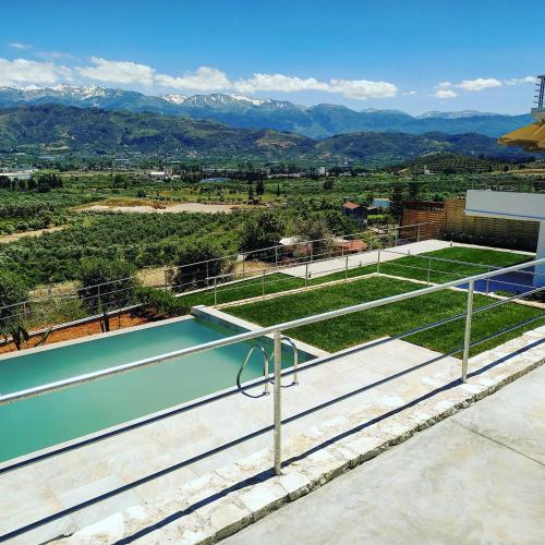 a view of a tennis court with mountains in the background at Villa Oasis in Galatás