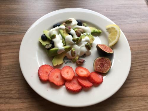 a plate of food with fruits and vegetables on a table at East Hillerton House in Crediton