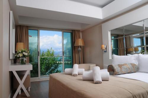 a bedroom with a large bed with a large window at Alesta Yacht Hotel in Fethiye