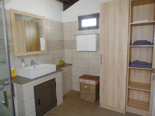 a bathroom with a sink and a mirror at Luxury Cosy Guesthouse in Pamplemousses Village