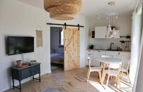 a kitchen and dining room with a table and chairs at Studio 33 Władysławowo in Władysławowo